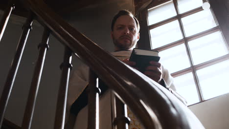 Priest on the stairs