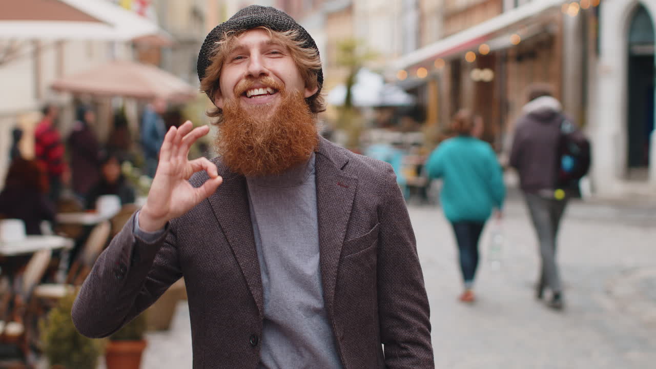 Happy cheerful young man showing ok gesture positive like sign approve something good celebrate