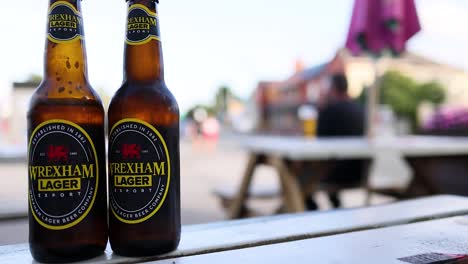 two beer bottles on a picnic table