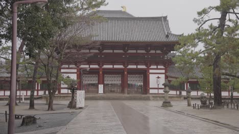 empty streets at entrance of todaiji temple, nara japan on rainy day