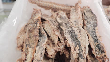 Pack-Of-Dried-Fish-On-White-Container