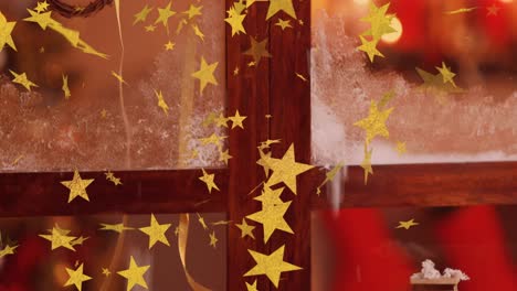 animation of stars flying over christmas decorations in window