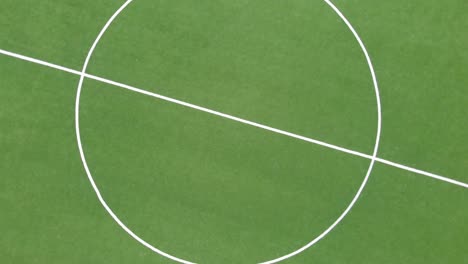 Top down rotate zoom in view of soccer football field stadium in the day time