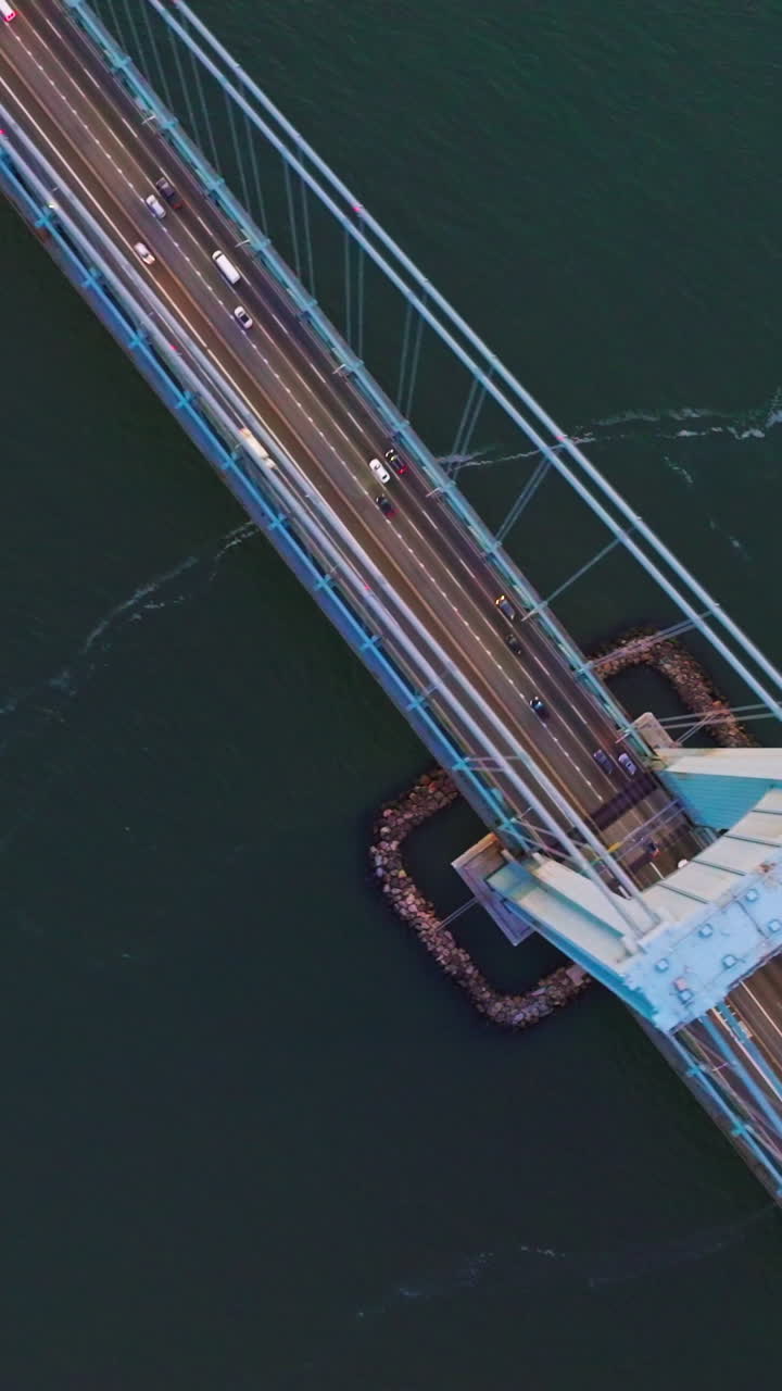 Whitestone Bridge in New York. Powerful construction over East River. Aerial perspective on the bridge and cars moving along it. Vertical video