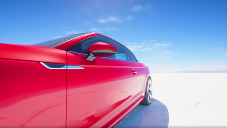 red convertible car on a salt flat