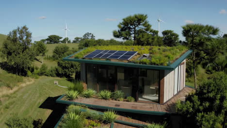 aerial view of modern house with green roof and solar panels