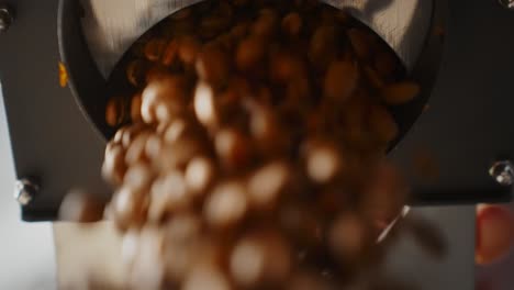 coffee beans discharging from a grinder