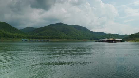 4K-Cinematic-landscape-nature-panoramic-footage-of-the-Mae-Kuang-Dam-Lake-at-Doi-Saket,-Northern-Thailand-on-a-sunny-day-while-sailing-on-a-moving-boat,-close-to-the-water