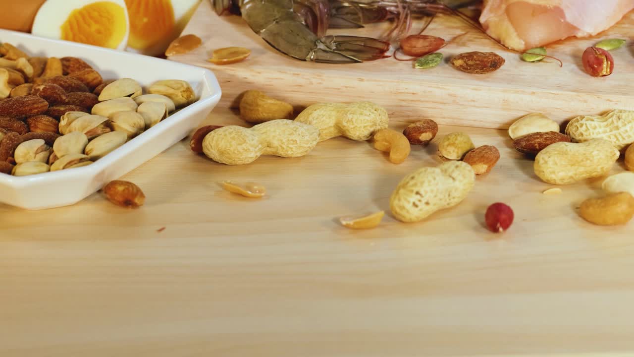 En levende presentasjon av proteinrike matvarer inkludert kjøtt, nøtter, meieriprodukter og sjømat, arrangert på en treoverflate med sterk belysning