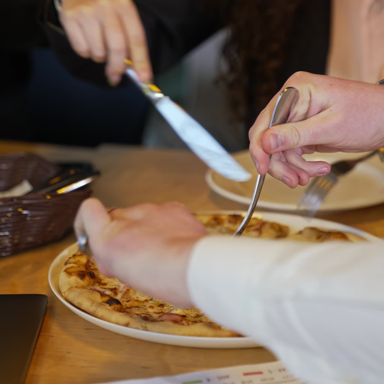 Eating pizza during lunch break. Colleagues cutting pizza in the company cafeteria. Lunchtime at work