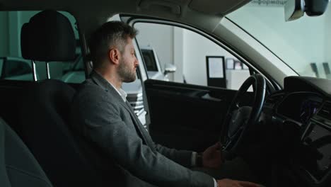 man checking out car interior at dealership