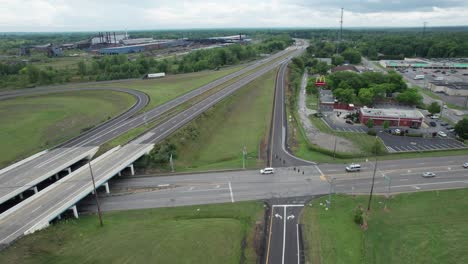 drone capture concrete made intersection where numerous car are travelling on a cloudy day