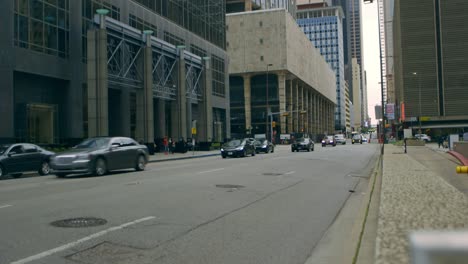 cars driving through downtown dallas on a nice morning