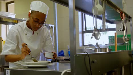 female chef garnishing food on plate 4k