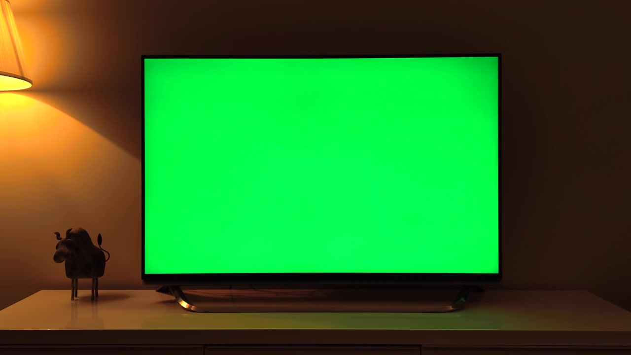 Television with Green Screen in Dimly Lit Living Room