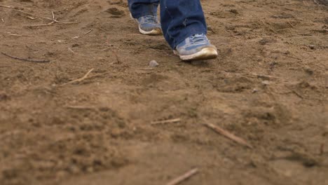 solitary person feet walking across golden sand