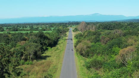 A-small-and-rustic-road-in-northern-Argentina,-with-the-immense-Andes-Mountains-in-the-background