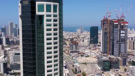aerial view of modern cityscape with skyscrapers and construction