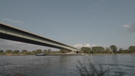 Moving-ships-under-zoo-bridge-in-Cologne,-Germany-in-summer