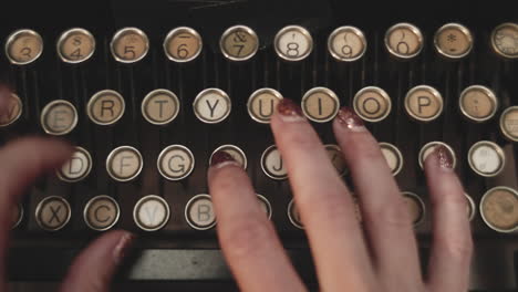 female hand is typing text on old historic typewriter,close up dolly shot