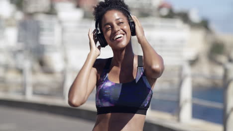 woman dancing outdoors with headphones