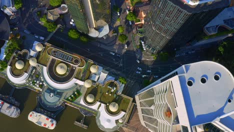 Top-down-View-Of-Light-Traffic-on-Eagle-Street-with-Riparian-Plaza-and-Ferry-terminal,-Brisbane-City---Australia