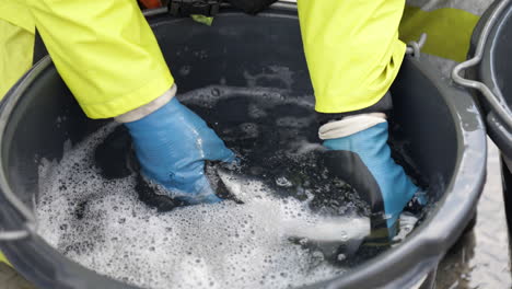 veterinarian with protective gear checks salmon skin for ectoparasites