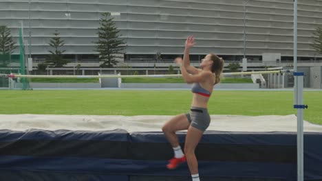 caucasian athlete doing high jump