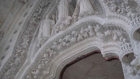 sagrada familia tilt down interior door detail on the statues 4k 30fps