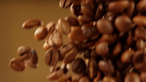 Falling-coffee-beans-on-the-brown-background-4k