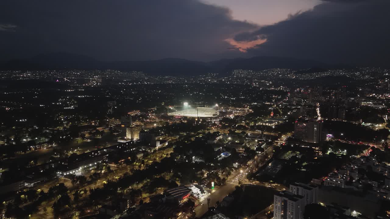 South of Mexico City, when night falls and city lights come on, an illuminated stadium can be seen in distance
