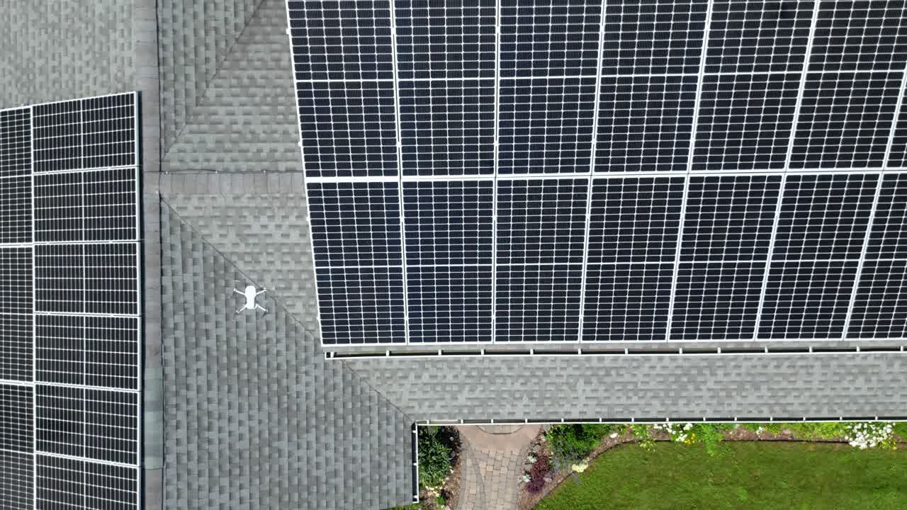 Drone solar panel roof inspection of home during sunny daylight in residential neighborhood