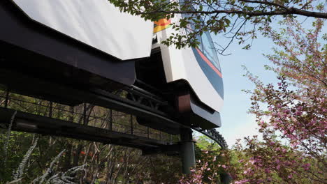 Low-Angle-View-Of-A-Traveling-Monorail-Train-In-Hwadamsup-Arboretum-In-Gwangju,-South-Korea