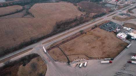 White-semi-truck-and-trailer-enters-on-road-making-a-right-turn