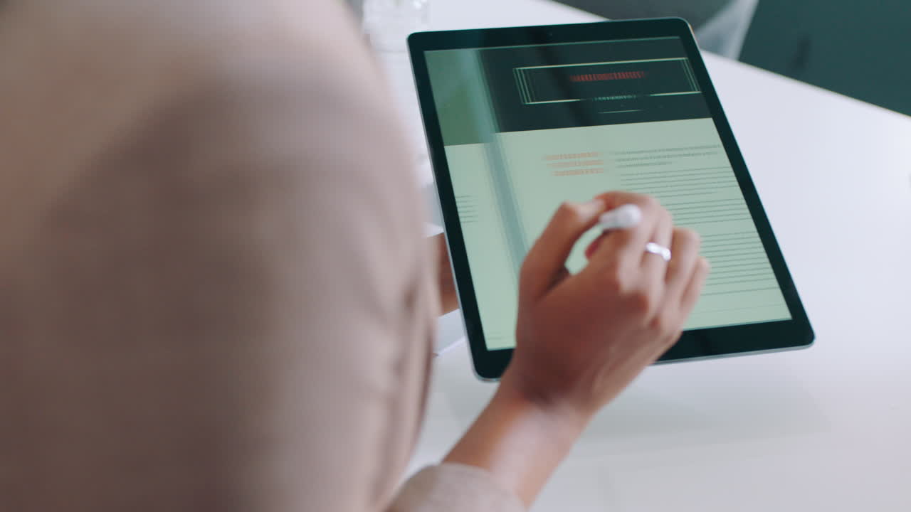 Close-Up of Hand Using Stylus on Digital Tablet for Business Review