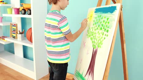 little boy painting a picture