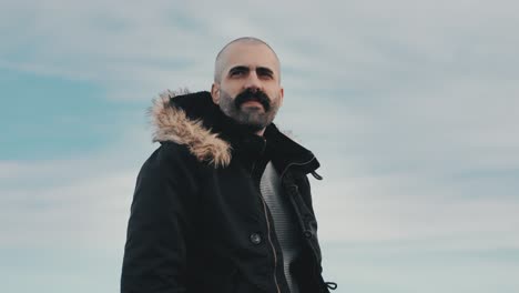 caucasian man looks at the horizon, surrounded by the beauty of nature