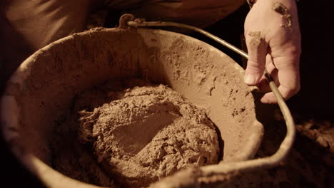 SLOW-MOTION-The-clay-mix-being-dumped-into-the-plasterers-bucket