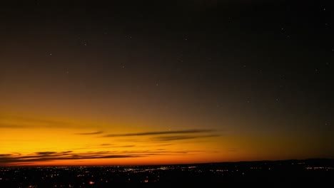 vibrant sunset over a distant city landscape with stars