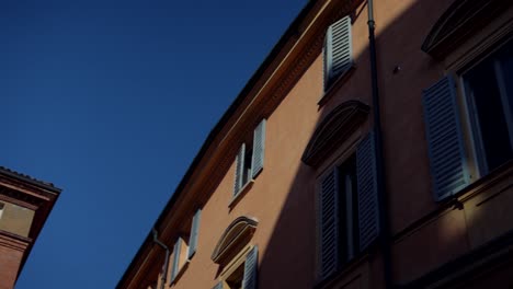 two historic buildings with shutters in italy