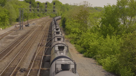 a-long-row-of-oil-tankers-pulling-away-view-from-above