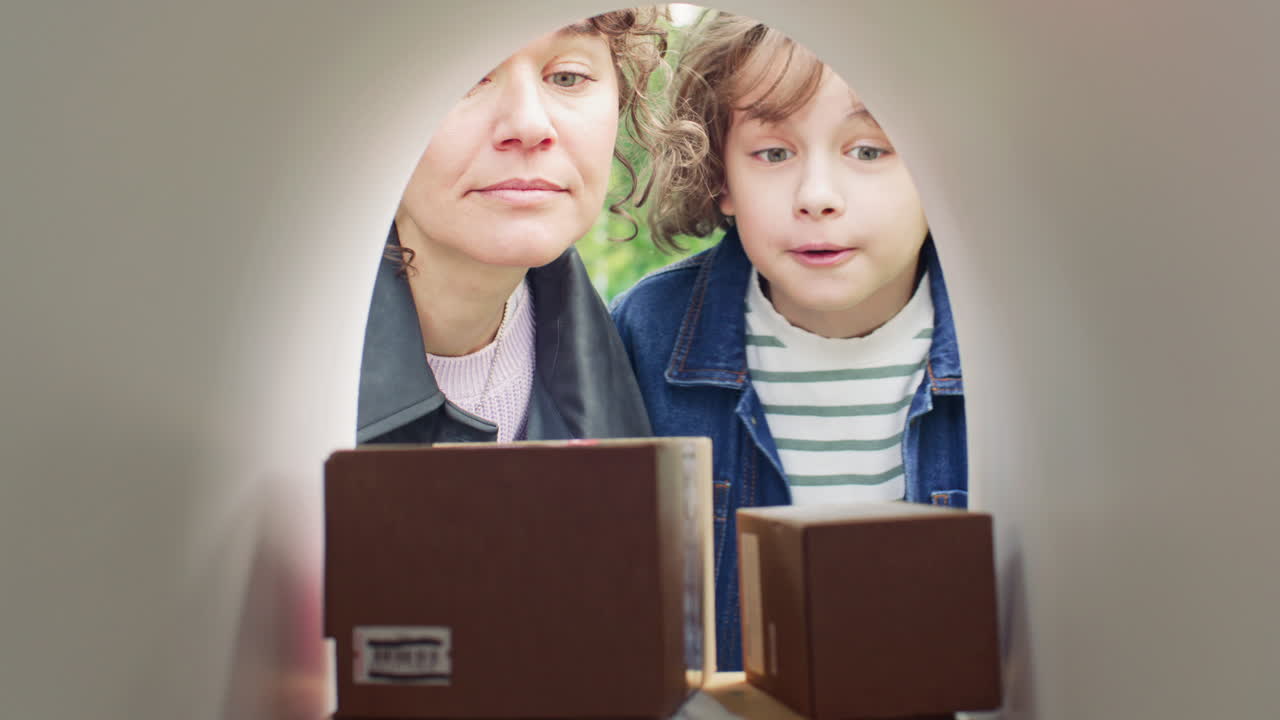 Woman and Young Son Retrieving Parcels and Letters from Mailbox