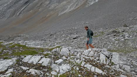 Hiker-walking-trough-mountain-amphitheater-followed-Rockies-Kananaskis-Alberta-Canada