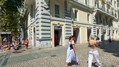 people walking and shopping on naples street