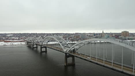 aerial establishing shot of centennial bridge connecting davenport, iowa and rock island, illinois