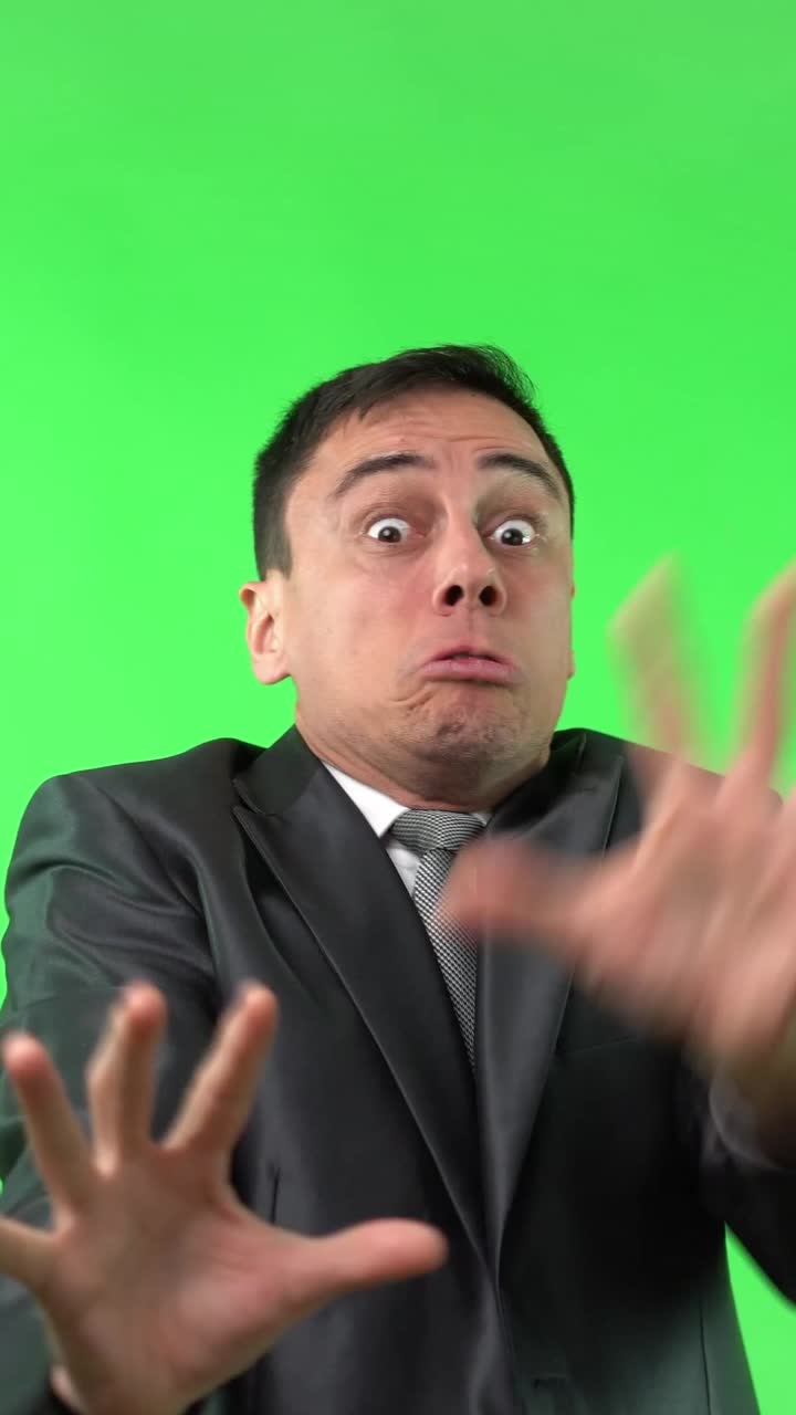 Man in Suit Expressing Fear and Panic on Green Screen