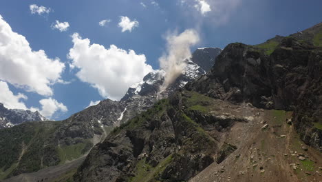 Aerial-shot-of-Nanga-Parbat,-Fairy-Meadows-Pakistan,-looking-up-towards-a-mountain-peak-with-clouds-coming-off-ridge,-cinematic-wide-drone-shot