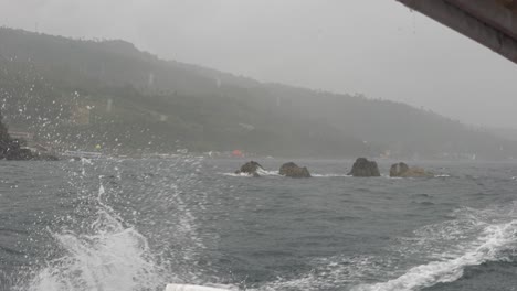 boat sailing in rough seas typhoon rain monsoon slow-mo 4k