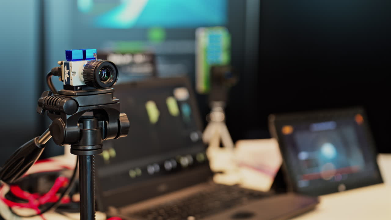 Close up of a professional camera filming on a tripod on a blurred background