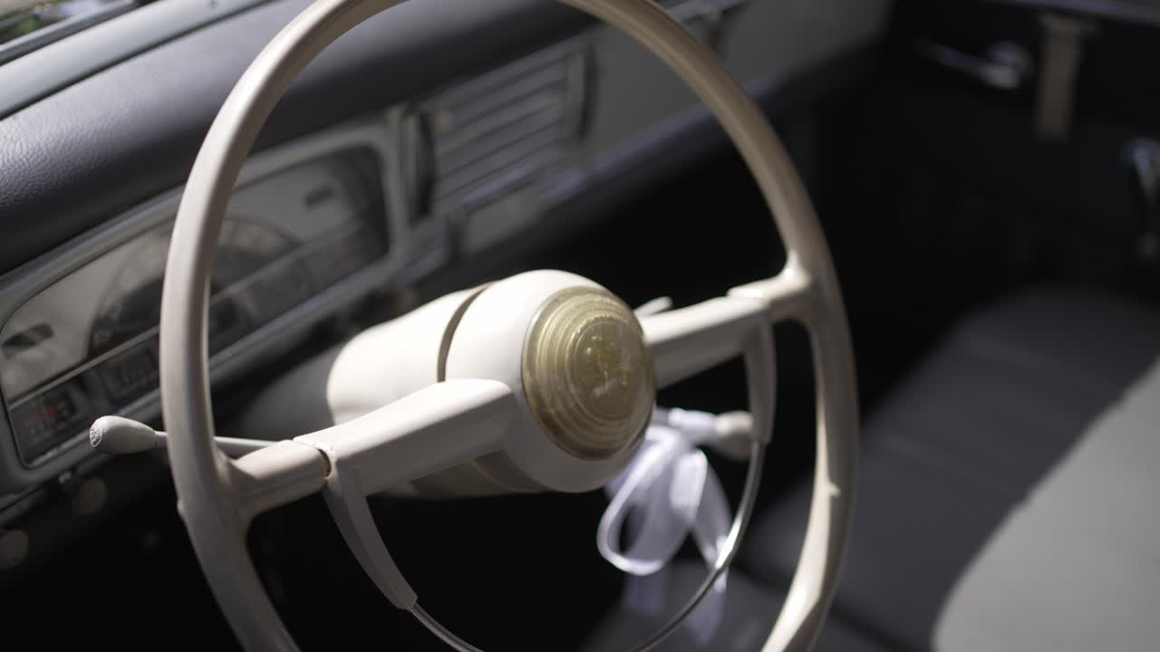 classic car interior with retro ivory steering wheel and soft daylight shadows